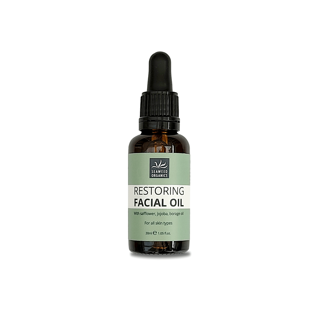 Plant-based SEAWEED ORGANICS Restoring Facial Oil in glass dropper bottle on natural fabric