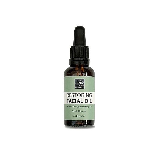 Plant-based SEAWEED ORGANICS Restoring Facial Oil in glass dropper bottle on natural fabric
