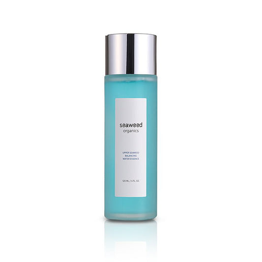 Glass bottle of Seaweed Organics Balancing Water Essence reflecting morning light